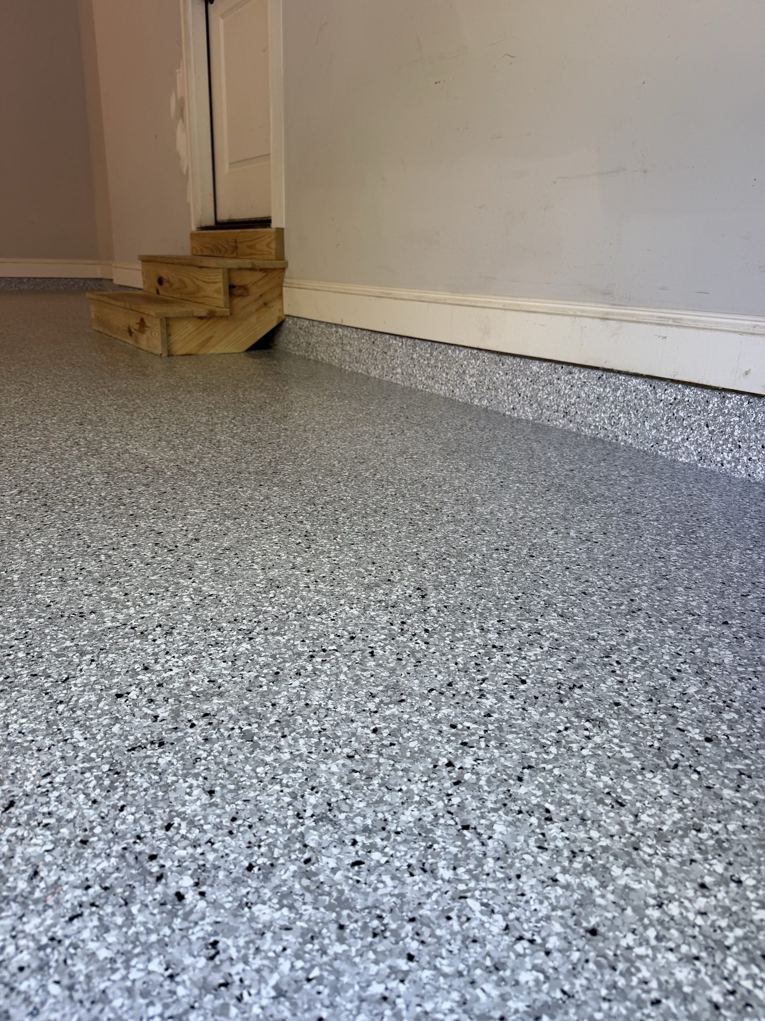 Flake epoxy garage floor with coated cove base by Southern Surfaces LLC