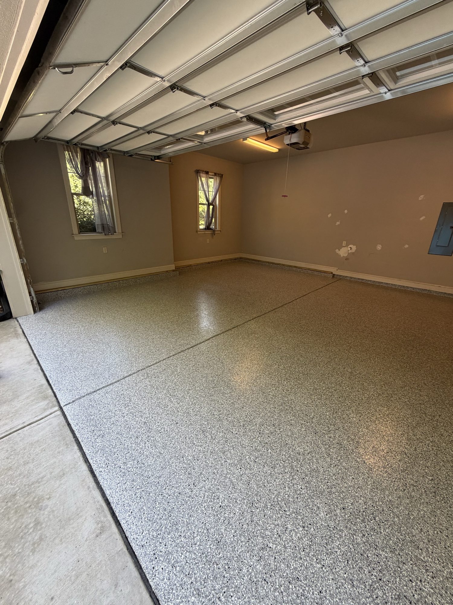 Gray flake epoxy two-car garage floor by Southern Surfaces LLC